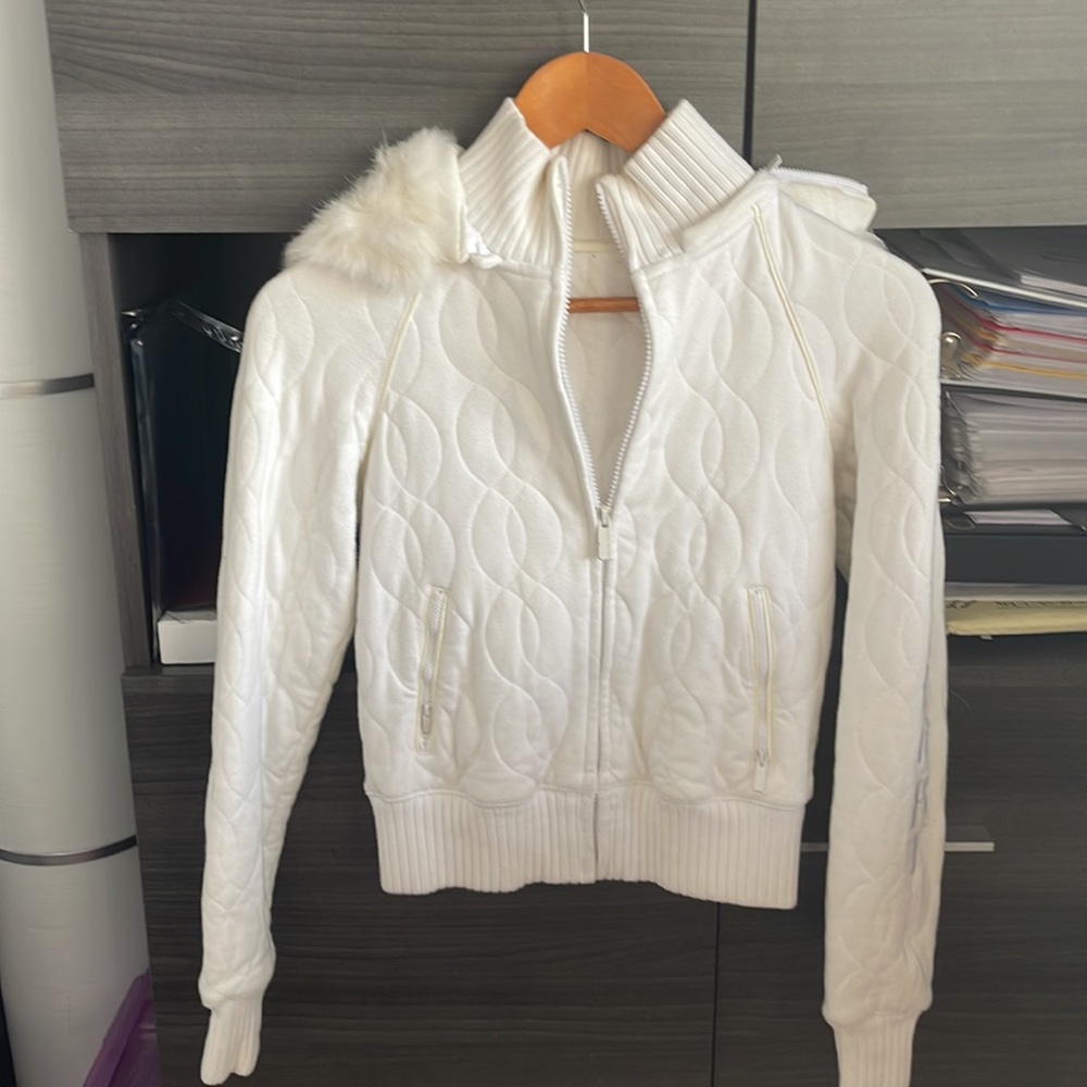 Bebé Sport white Jacket. It has a little stain in both side arm.